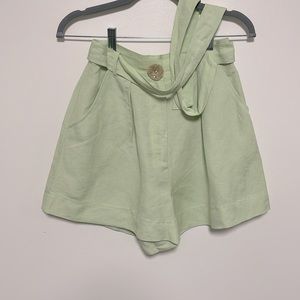 Green linen high waisted shorts with matching belt and pockets